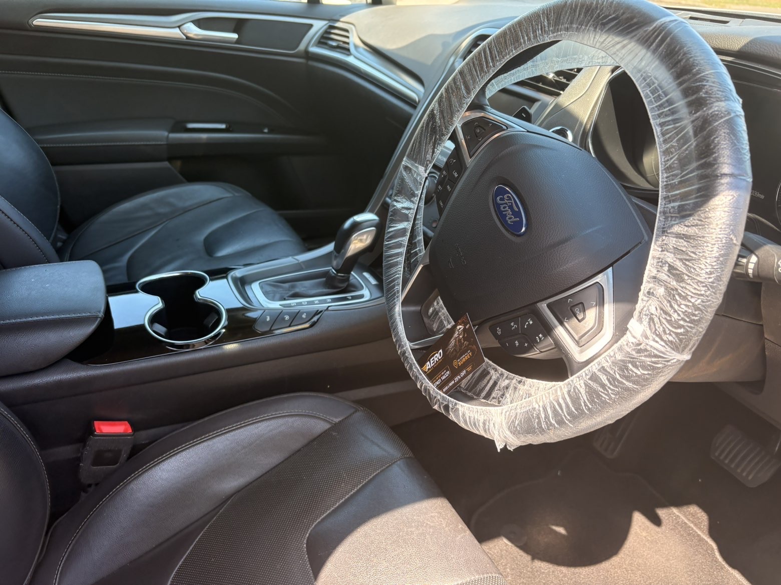 Ford Mondeo interior finished with Aero Mobile Valeting card on the wheel